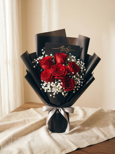 Celeste Noir bouquet of six red roses in black wrapping